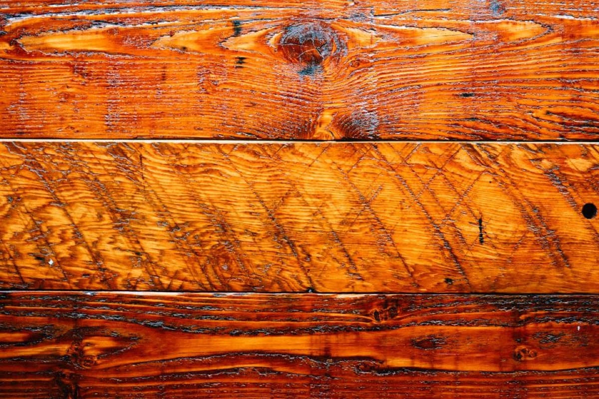 Close-up wood grain on a finished board face that daily care and clear-coat maintenance protect