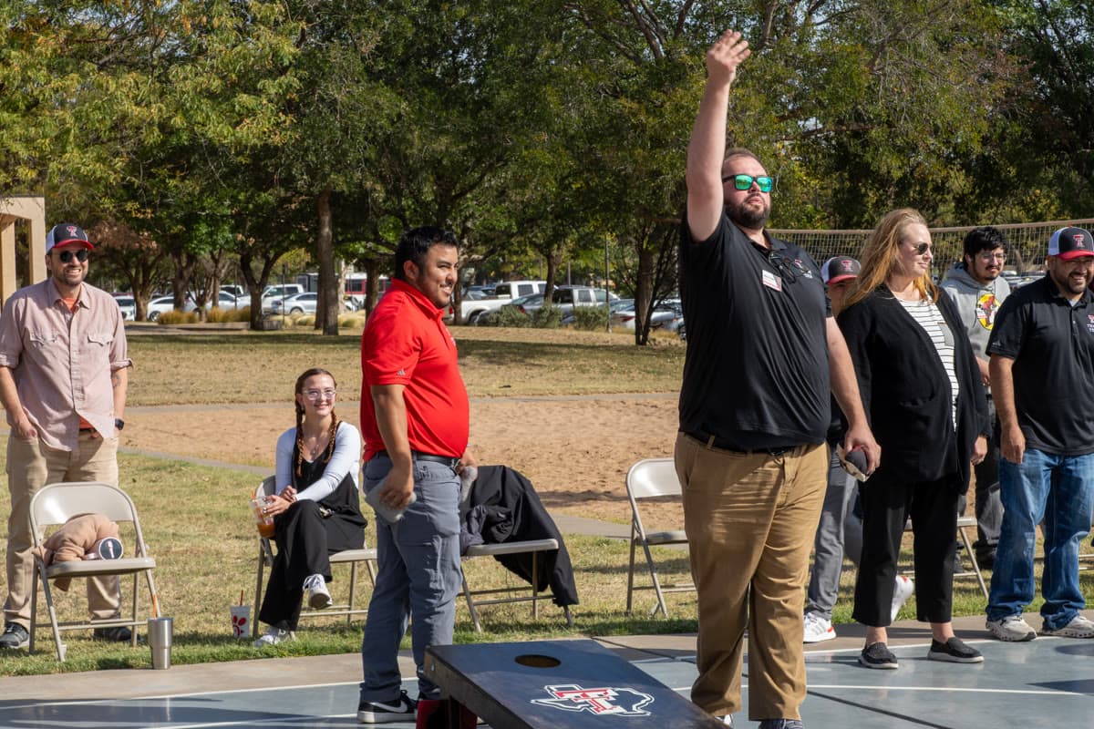 SECC cornhole tournament players competing on regulation boards during championship play