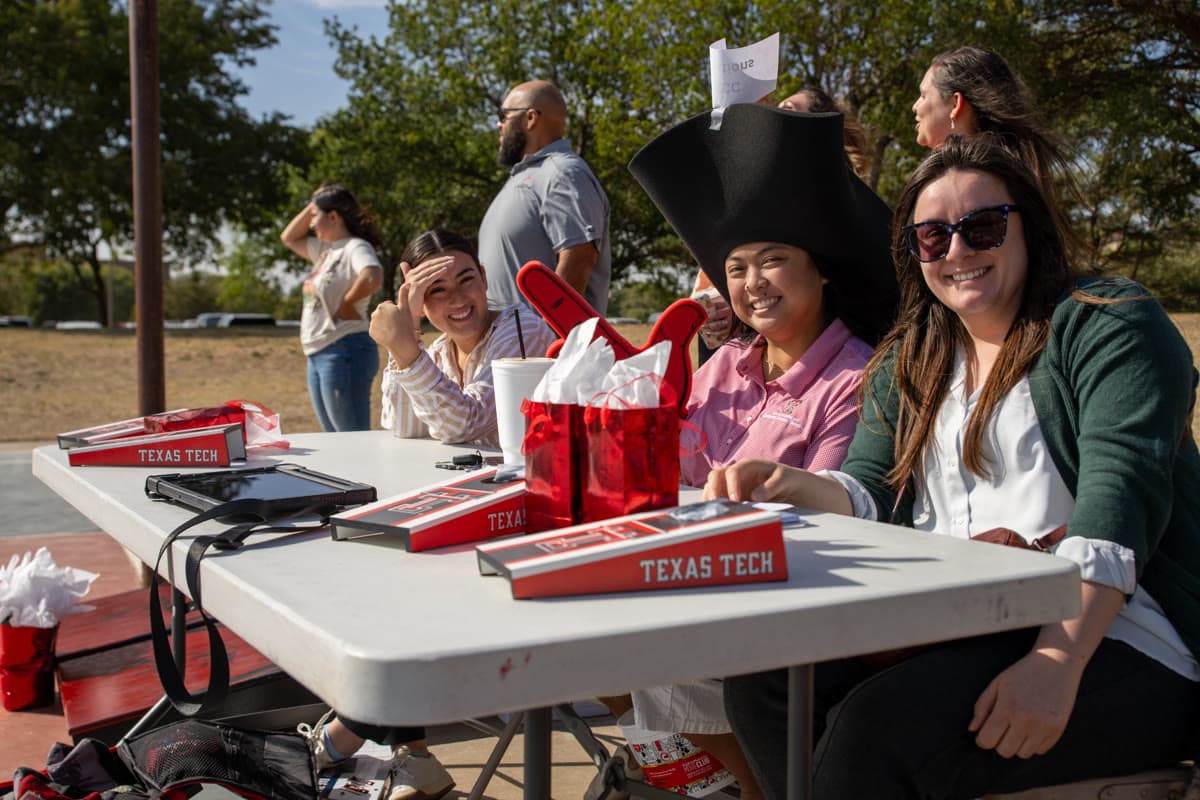 Players compete at a regulation cornhole tournament with boards set at official distance