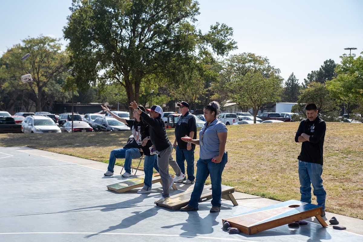 Two regulation cornhole boards set the standard distance apart on a court during a tournament