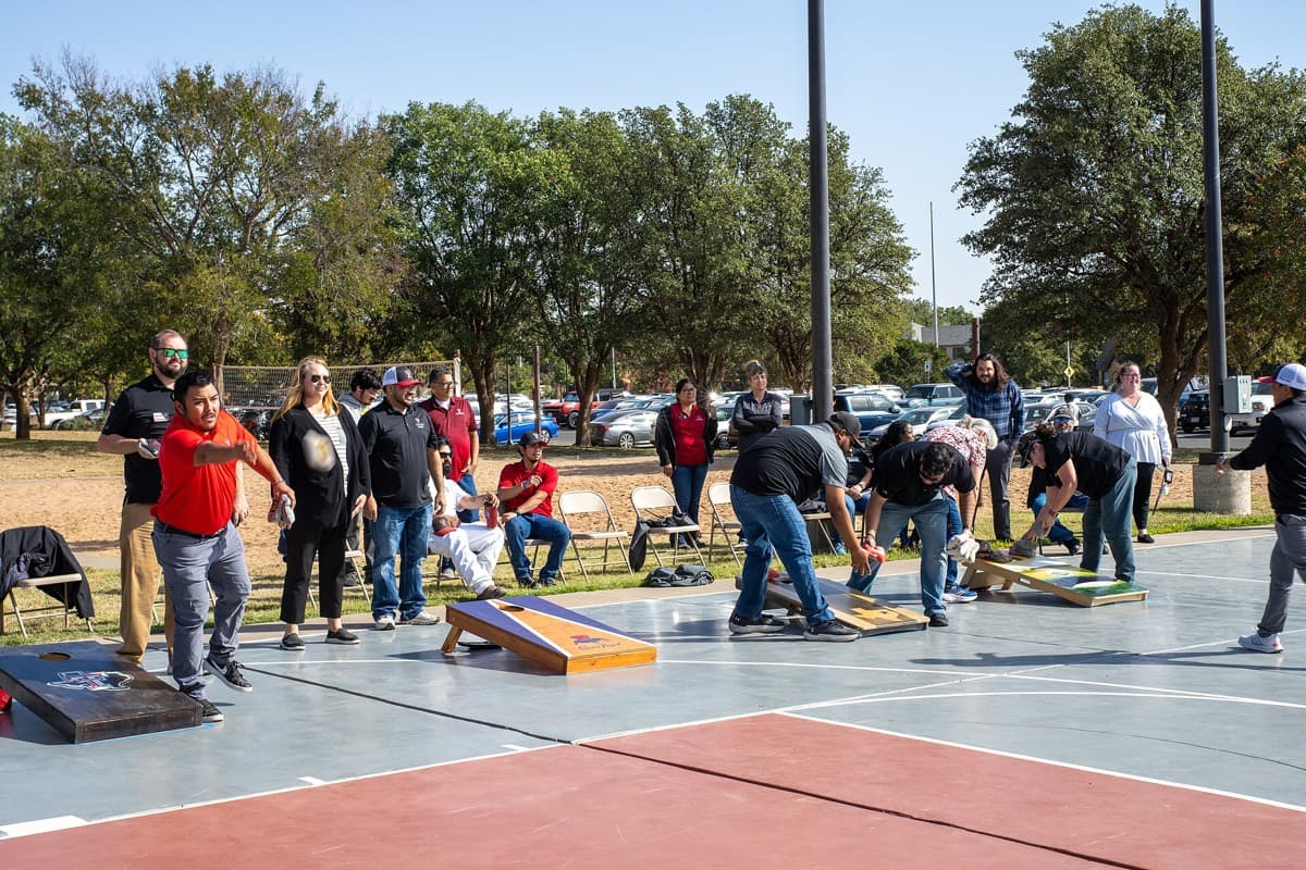 Regulation cornhole boards set at tournament distance on an outdoor court